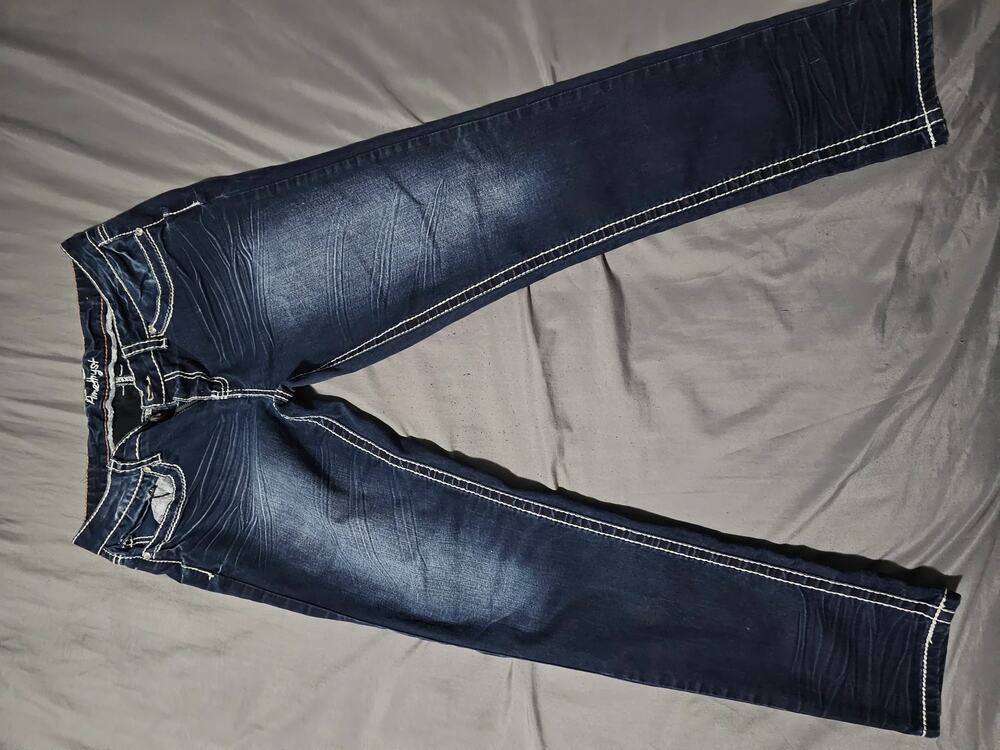 Dark wash denim jeans contrast stitching faded whiskering